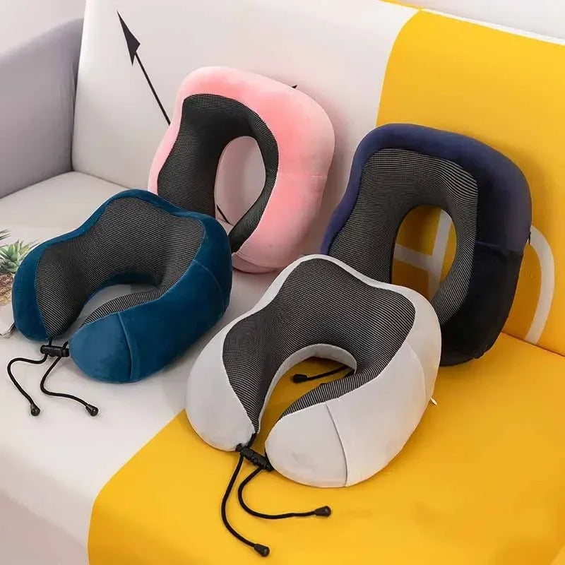Set of four neck pillows in different colors on a colorful sofa.