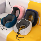 Set of four neck pillows in different colors on a colorful sofa.