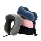 Four travel neck pillows in gray, blue, light blue and pink on a white background