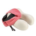 Pink neck pillow with black interior cover taken off foam against a white background