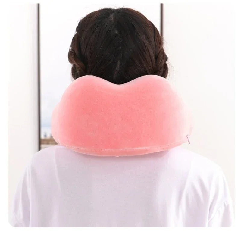Person wearing a pink neck pillow against a white background
