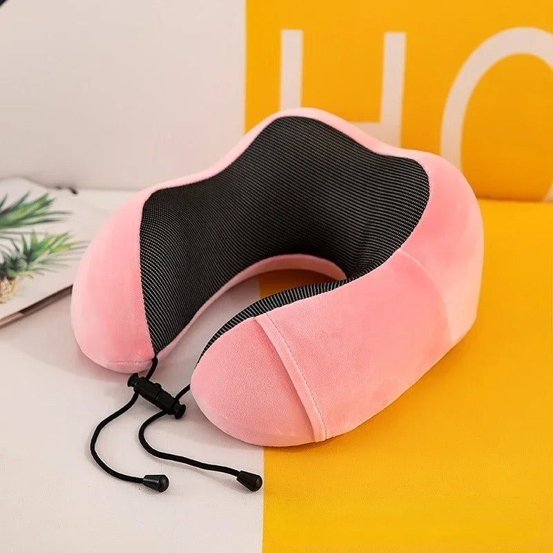 Pink neck pillow with black mesh on a yellow and white background